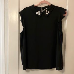 Elle flutter sleeve top. Lightweight semi sheer material. Cute collar detail.